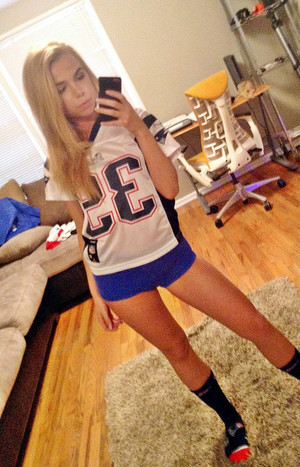 A young blonde in a T-shirt cheerleader