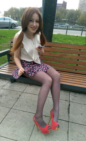 Busty teen girl spreading her long legs